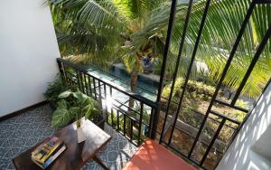 an overhead view of a balcony with a table and a pool at Central Corner Suite in Siem Reap +87 photos