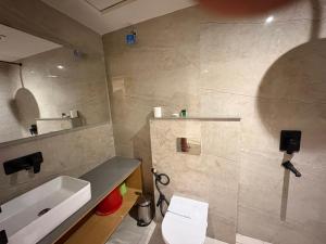 a bathroom with a sink and a mirror at Eve Hotel in Varanasi +19 photos
