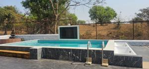 a swimming pool with a sink and a tub at Hangout Villa in Malavli +20 photos