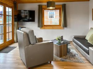 a living room with a couch and a table at Lodge 2 - Uk51263 in Glasgow