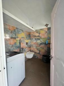 a bathroom with a sink and a toilet at Chamundi Temple-Hill View in Mysore
