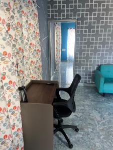 an office with a desk and a chair in a room at Chamundi Temple-Hill View in Mysore