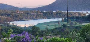 a lake in the middle of a valley with trees at African Bushveld 129A 1 x Bachelor Unit in Buffelspoort