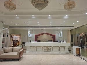 a store lobby with a white counter and a couch at Hotel Royal Palace in Sāgar +189 photos