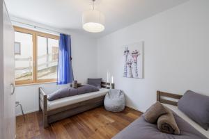 a bedroom with two beds and a window at Chasa AlpVista in Sent