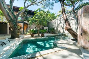 a swimming pool in a yard with trees at Welcome to Paradise - Luxurious Studio Oasis "Urania" with Pool and Lush Tropical Gardens in Sayulita