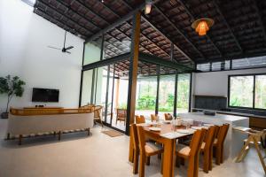a dining room with a table and chairs at The Villa - Premium Private Pool Villa in Vaduvanchal