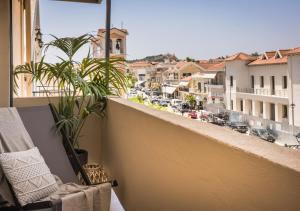 a balcony with a view of a city at Nomāde Agora Suites - Lixouri Town Centre, Kefalonia - Private Balconies in Lixouri