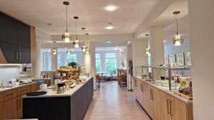 a large kitchen with wooden cabinets and a large island at Dietrich-Bonhoeffer-Hotel Berlin Mitte in Berlin