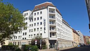 a white building on the side of a street at Dietrich-Bonhoeffer-Hotel Berlin Mitte in Berlin