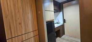 a door leading to a bathroom with a sink at Alton by Be rent in Jatingaleh