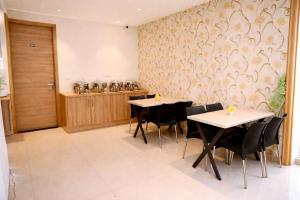 a restaurant with two tables and chairs in a room at Hotel Diamond Villa and Banquet in Amritsar +40 photos