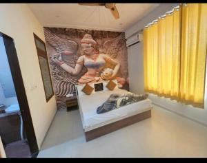 a bedroom with a painting of a woman on the wall at Hotel Shree Govind Dev and Restaurant in Khātu