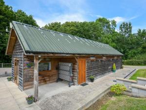 a small wooden cabin with a metal roof at Oak - Glamping Pod - Uk49946 in Oswestry