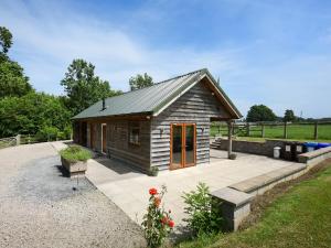 a small cabin with a patio in a field at Oak - Glamping Pod - Uk49946 in Oswestry