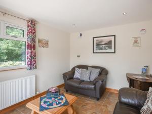 a living room with a couch and a table at Oak - Glamping Pod - Uk49946 in Oswestry +9 photos