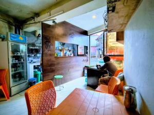 a person sitting at a table in a restaurant at ONLY CAFE Hotel in Chopta