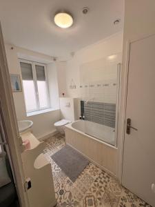 a bathroom with a tub and a toilet and a sink at The LightHouse Chambres à louer in Châteaulin +16 photos