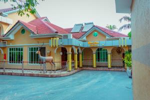 a house with a fake deer in front of it at Beaco Resort in Mbeya