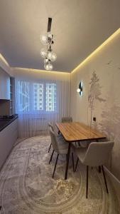 a dining room with a wooden table and chairs at Life park Osh 2 in Osh