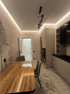 a dining room with a wooden table and chairs at Life park Osh 2 in Osh