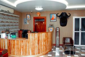 a bar with a cow head on the wall at Beaco Resort in Mbeya +91 photos