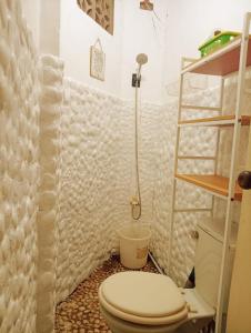 a bathroom with a toilet and a shower at Amwani Hideaway in Puerto Princesa City