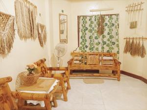 a living room with wooden furniture and a table at Amwani Hideaway in Puerto Princesa City