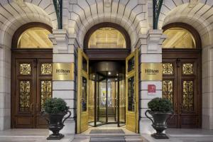 an entrance to a building with wooden doors at Hilton Paris Opera in Paris