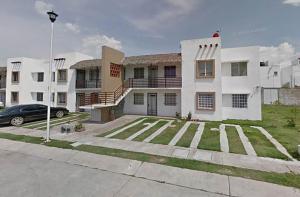 a large white house with a car parked in a parking lot at Autentico y Lindo Departamento in Puerto Vallarta