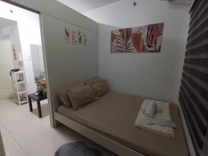 a small room with a bed in the corner at SFC Cool Suites by SMDC Tagaytay in Tagaytay +27 photos