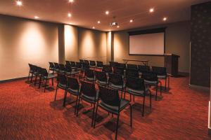 a lecture room with a bunch of chairs and a screen at Hampton By Hilton Cusco in Cusco