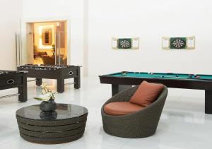 a living room with a pool table and a chair at SFC Cool Suites by SMDC Tagaytay in Tagaytay