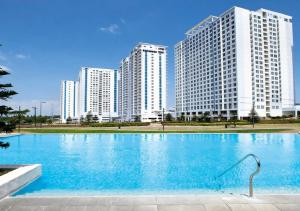 a large swimming pool with tall buildings in the background at SFC Cool Suites by SMDC Tagaytay in Tagaytay