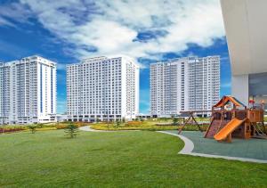 a playground in a park with tall buildings at SFC Cool Suites by SMDC Tagaytay in Tagaytay