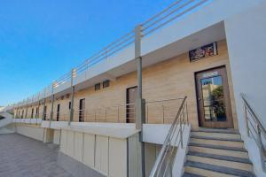 a building with stairs on the side of it at StayGuru Hari Om Residency in Bhuj