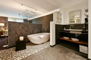 a large bathroom with a tub and a sink at Höll am Main in Rüsselsheim +27 photos