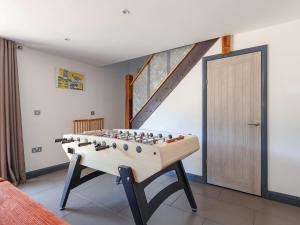 a foosball table in a room with a staircase at Rusty Barn in Gloucester +31 photos
