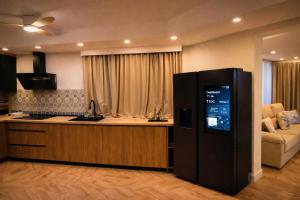 a kitchen with a refrigerator in a living room at Resort Villa Las Palmeras in Roquetas de Mar