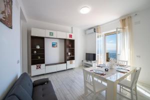 a living room with a table and a couch at VivimiHome - Casa Tiberio in Conca dei Marini