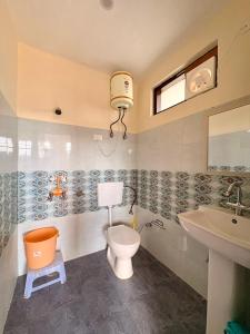 a bathroom with a toilet and a sink at Soma House Dharamkot in McLeod Ganj