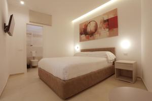 a bedroom with a bed and a table in it at Residenza del Centro in Fabriano +61 photos