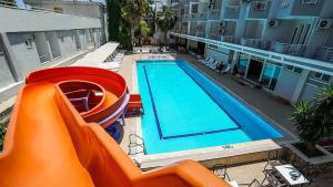 an image of a swimming pool with an slide at Nex Royal Beach in Antalya +27 photos
