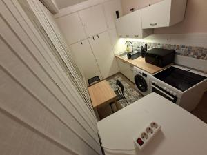 a small kitchen with a sink and a stove at Dombó apartman in Dombóvár