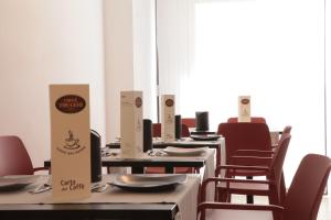 a dining room with tables and chairs with a sign that says eat a chef at Residenza del Centro in Fabriano