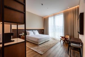 a bedroom with a bed and a desk and a television at Jacob Modiin in Modi'in-Maccabim-Re'ut