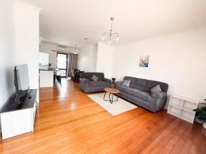 a living room with a couch and a tv at Sweet Home in Avalon in Lower Hutt