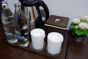 a tray with toilet paper and a bottle of water at TP Residence เคหะร่มเกล้า in Lat Krabang