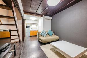 a living room with a bunk bed and a couch at YAGARA TERRACE HOUSE OSAKA Room A in Osaka