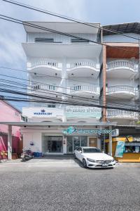 a white car parked in front of a building at Marshmallow House in Sathani Lak Si
